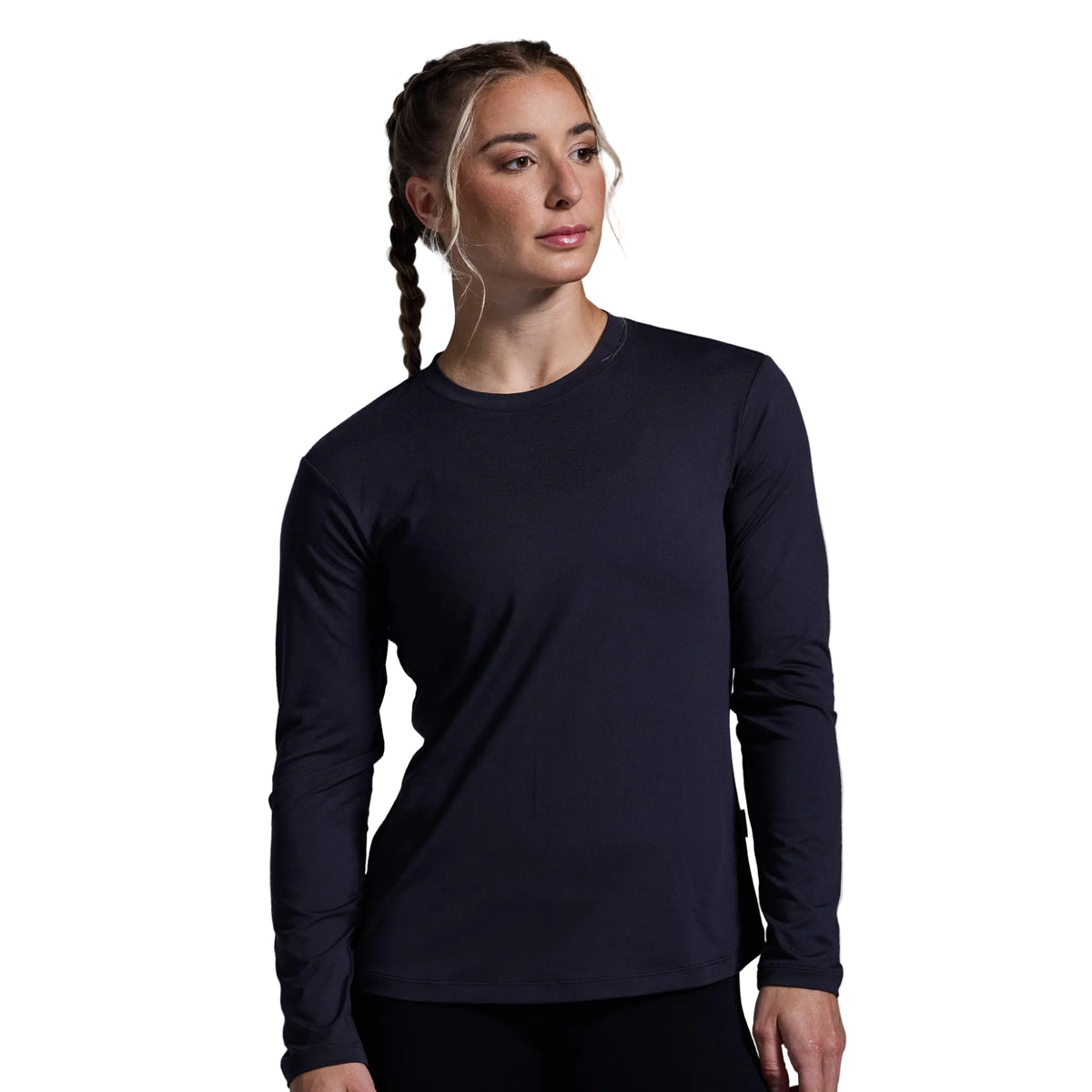 Woman wearing a black long-sleeve shirt against a gray background
