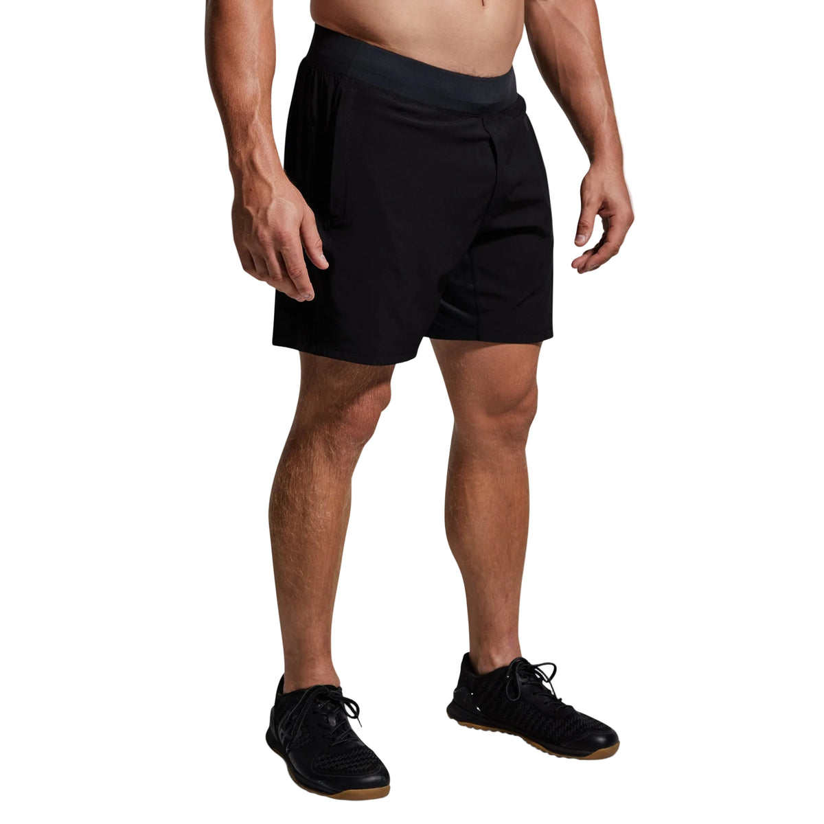 Person wearing black shorts on a gray background