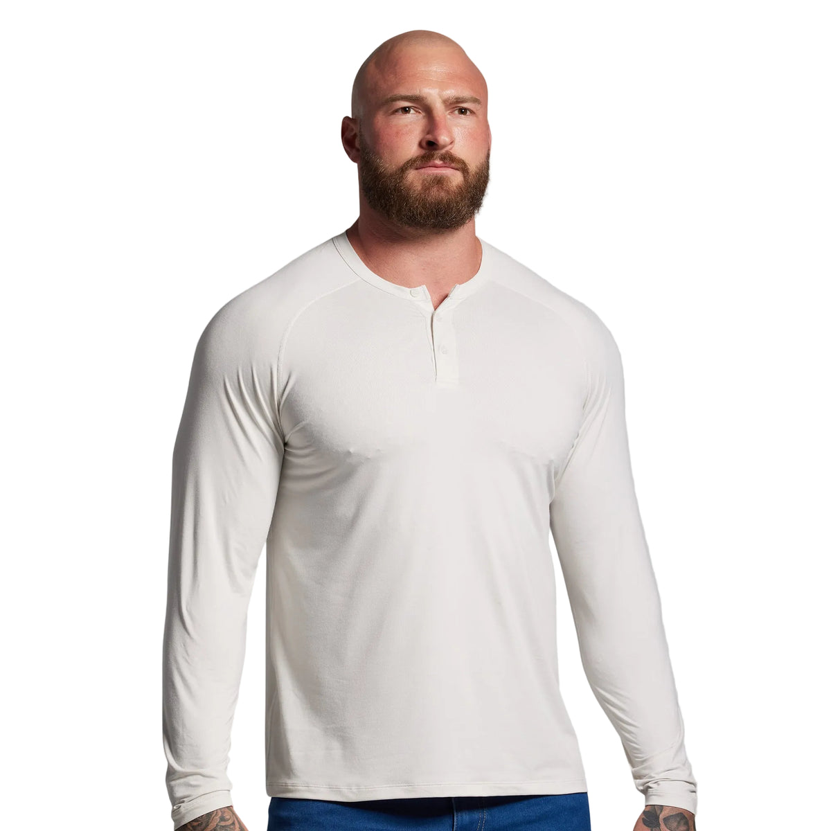 Man wearing a white long-sleeve shirt against a gray background