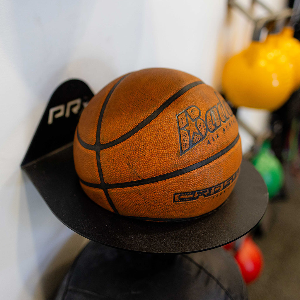 basketball stored in wall-mounted sports ball storage