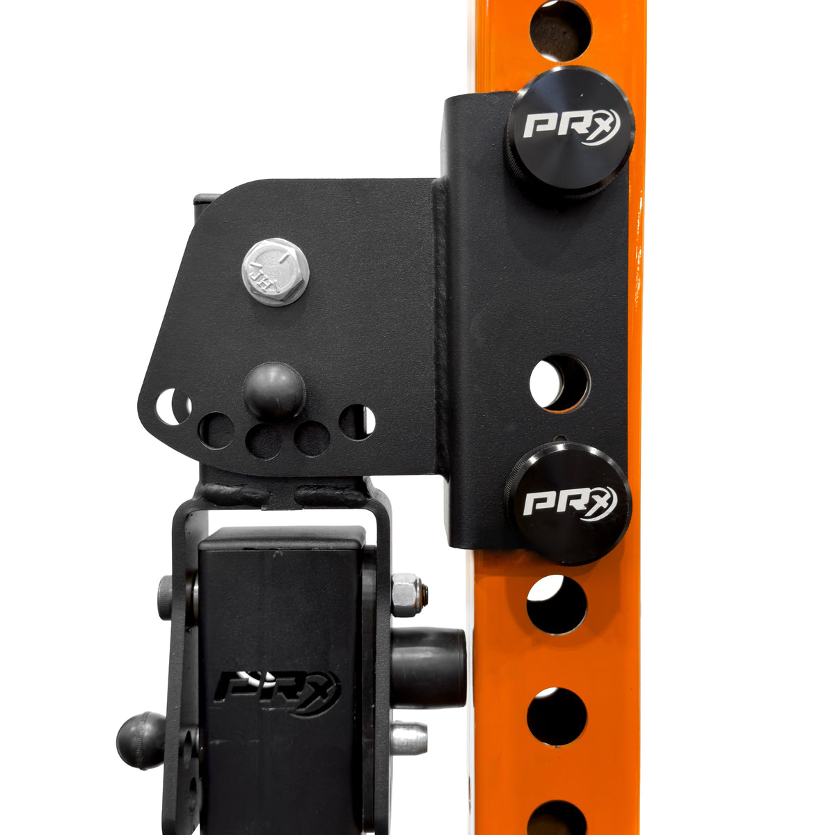 Close-up of a black mechanical component with PRX branding on an orange background