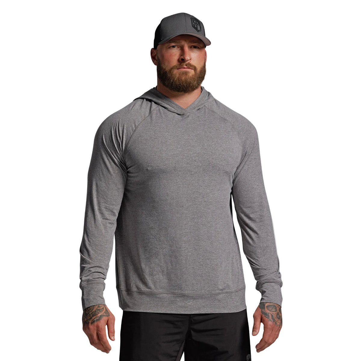 Man wearing a gray long-sleeve hoodie and cap on a light gray background
