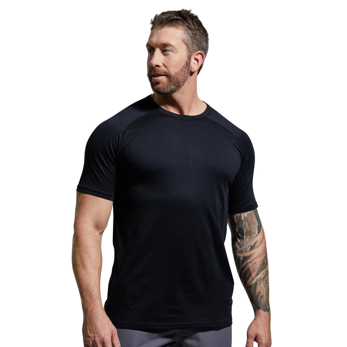 Man wearing a black t-shirt against a gray background