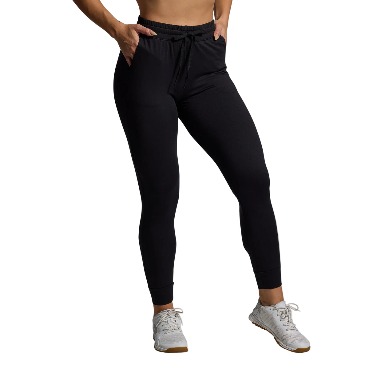 Person wearing black leggings on a gray background