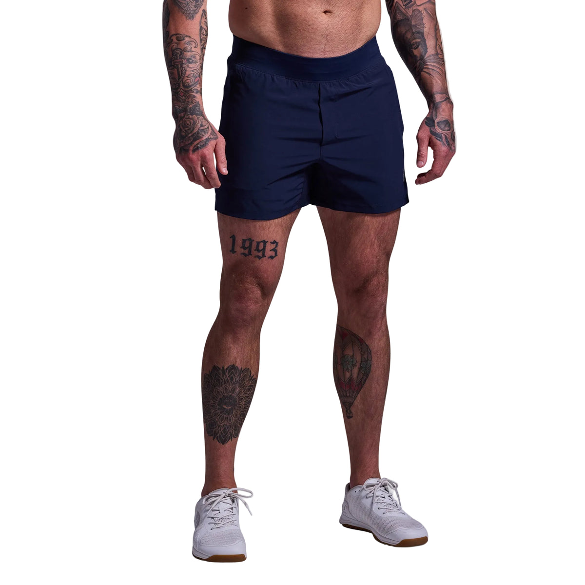 Person wearing navy shorts on a plain background