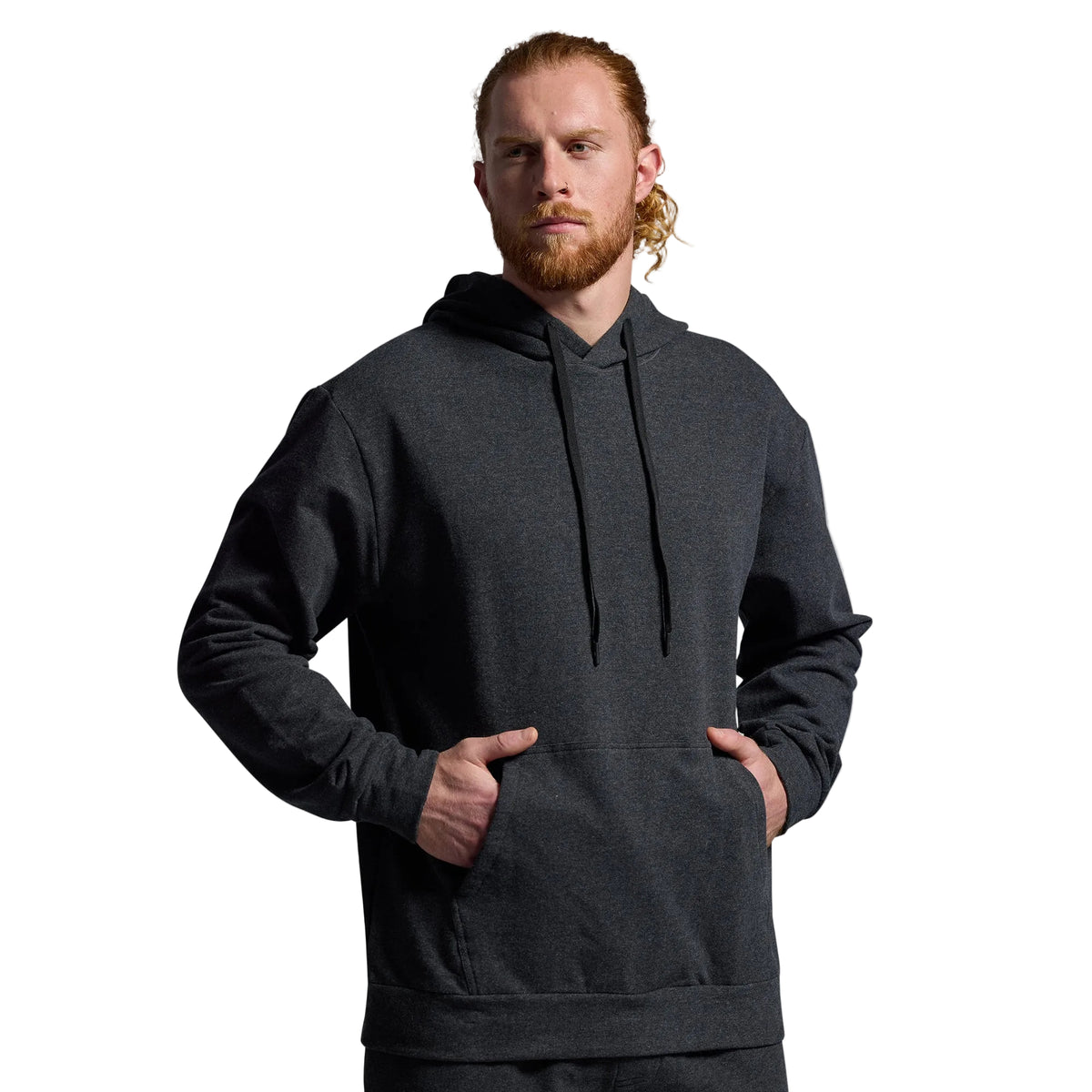 Man wearing a dark gray hoodie against a plain background