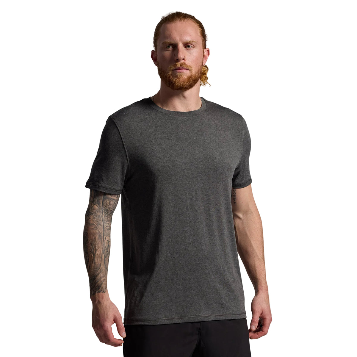 Man wearing a dark gray t-shirt against a plain background