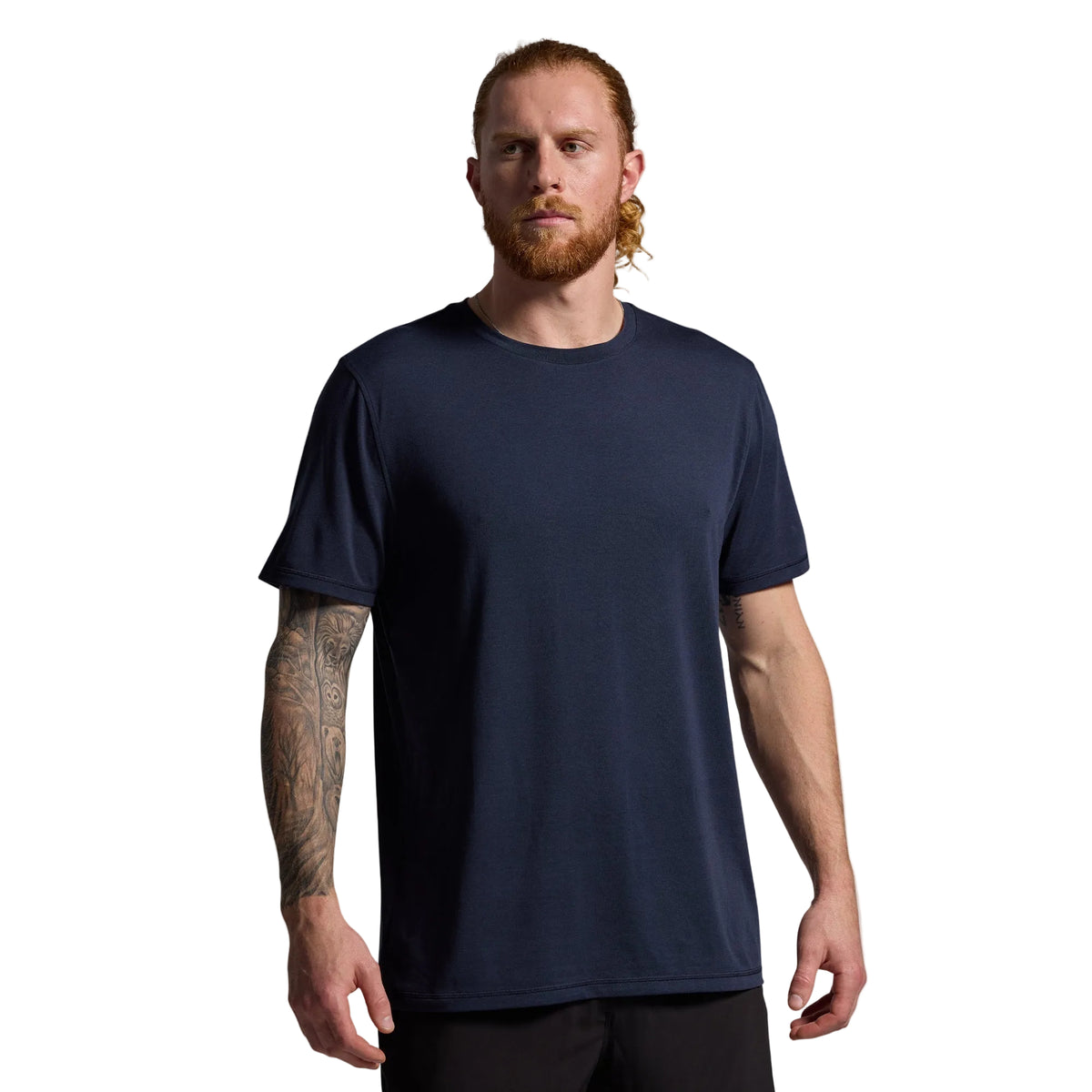 Man wearing a navy blue t-shirt against a gray background