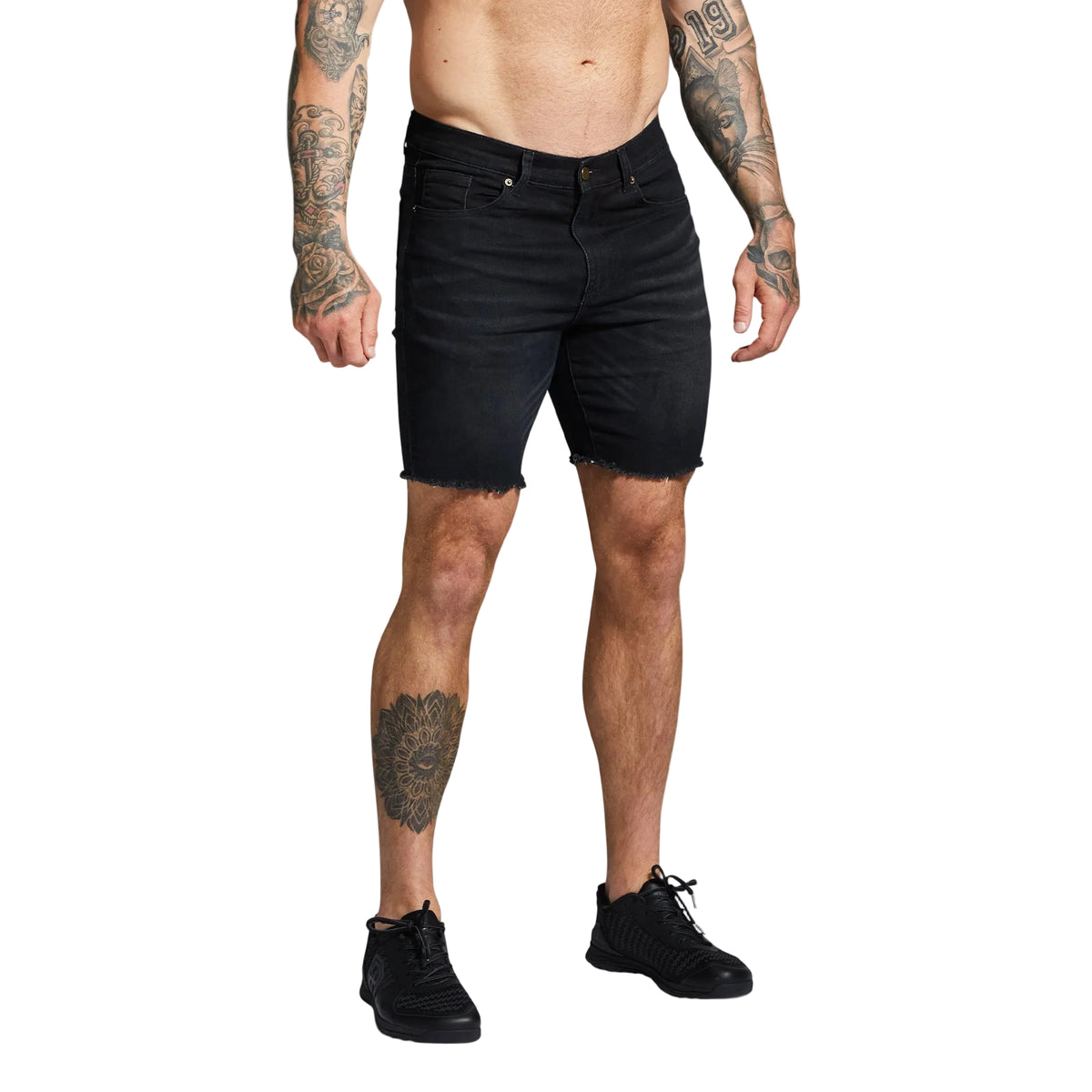 Person wearing black denim shorts on a gray background