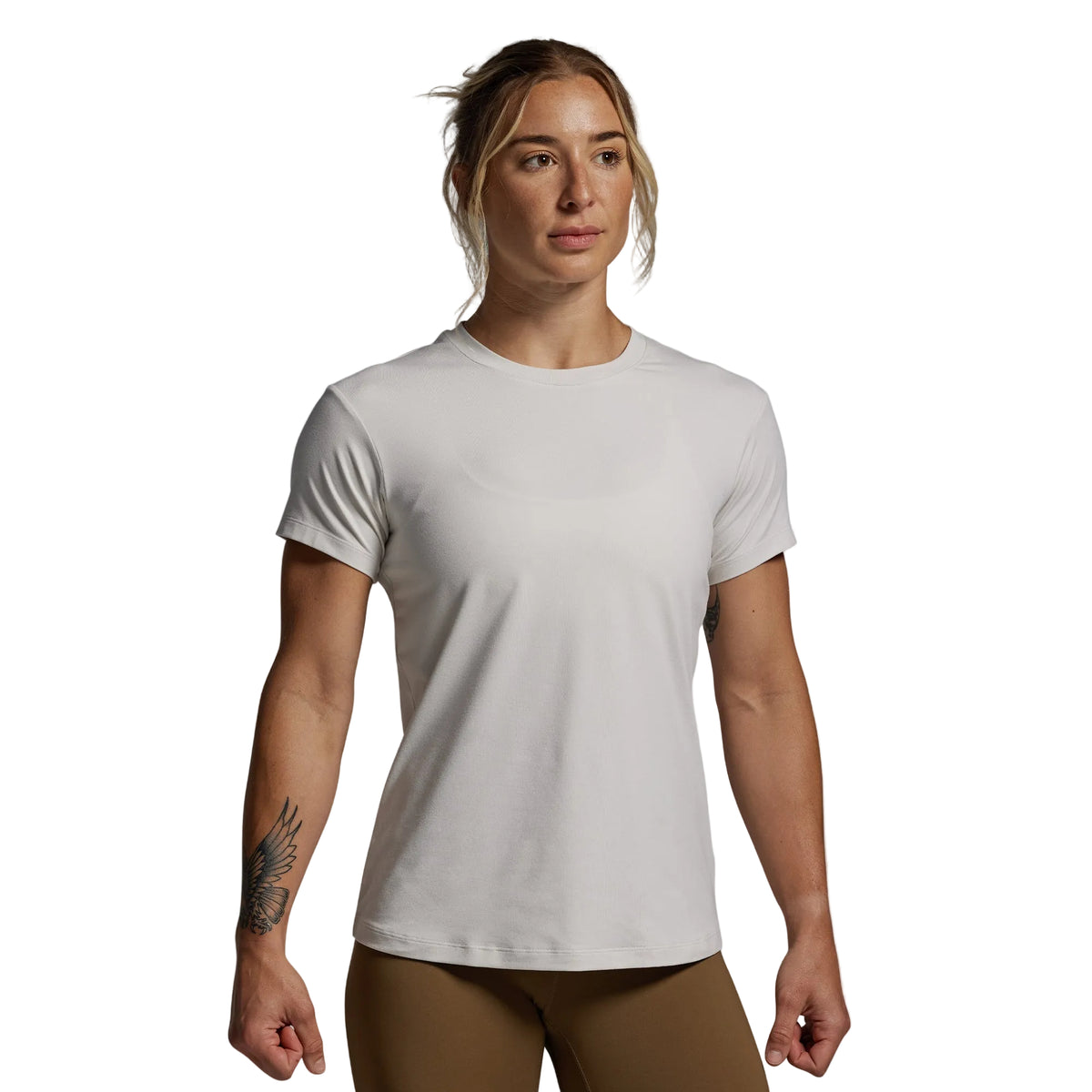 Woman wearing a plain white t-shirt against a gray background