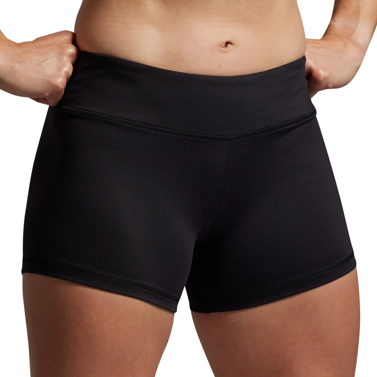 Person wearing black athletic shorts on a gray background