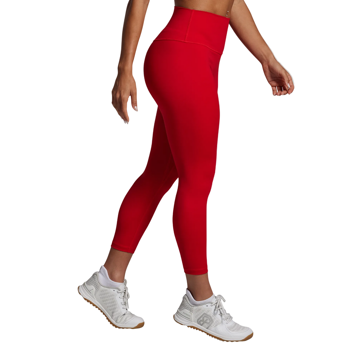 Person wearing red leggings and white sneakers on a gray background