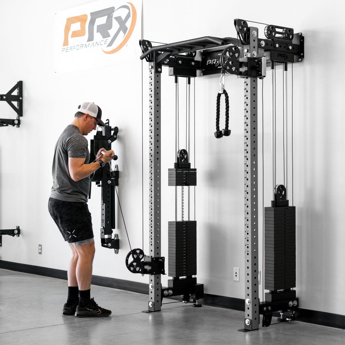 Person using a PRx fitness machine in a gym setting