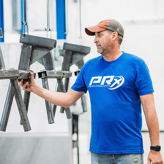 man in a blue shirt inspecting quality on PRx raw materials