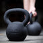Athlete using Kettlebell in background