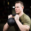 Athlete holding 33lb kettlebell for strength training