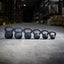 line up of various weighted kettlebells for strength training
