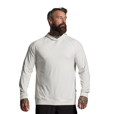 Man wearing a white hoodie against a gray background