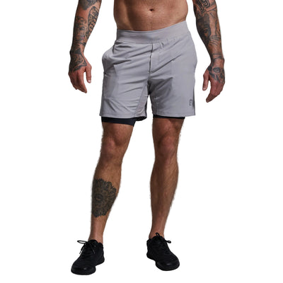 Person wearing gray athletic shorts on a plain background
