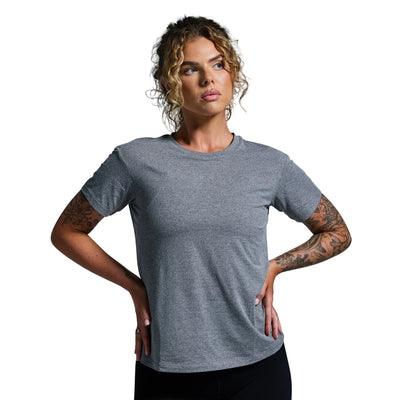 Woman wearing a gray t-shirt against a plain background