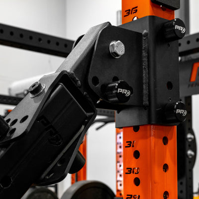 Close-up of an orange and black PRx rack system component in a warehouse setting.