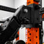 Close-up of an orange and black PRx rack system component in a warehouse setting.