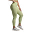Person wearing light green leggings on a gray background