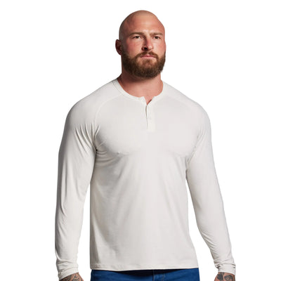 Man wearing a white long-sleeve shirt against a gray background