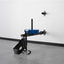Wall-mounted weightlifting device with blue weight plate on a gray floor.