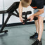 Man demonstrating adjustable feet on GRIND Foldable Bench..