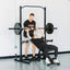 Woman bench pressing on GRIND Foldable Bench with man spotting her.