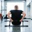 Man doing modified tricep dip on Door Mounted Pull-Up Bar sitting on the floor.