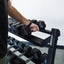 Man removing dumbbell from rack. 