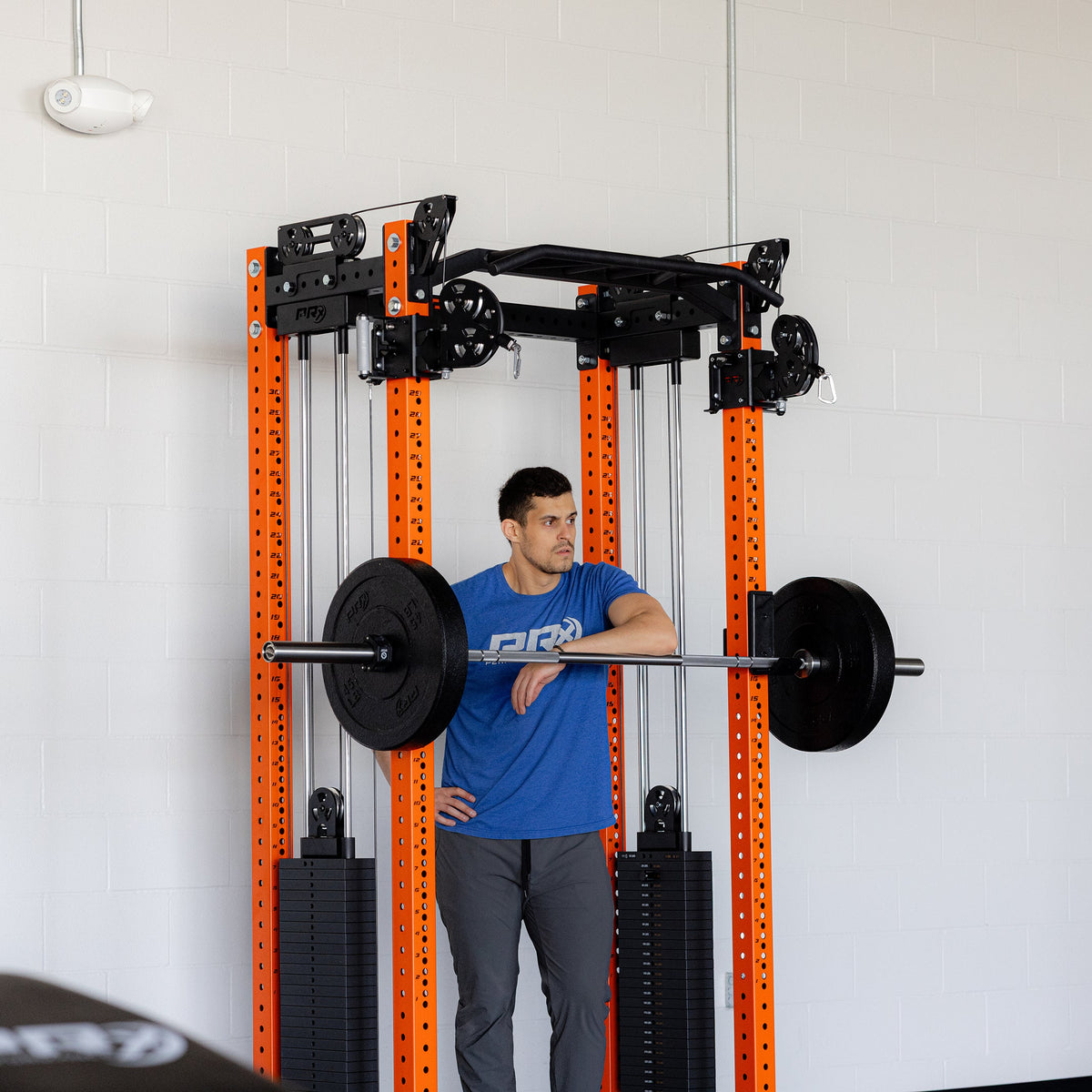 Person using a weightlifting machine in a gym setting