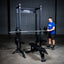 Build Limitless® Economy Half Rack with man loading a barbell