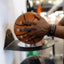 man placing basketball in wall-mounted sports ball storage