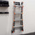 Ladder stored on wall-mounted ladder storage