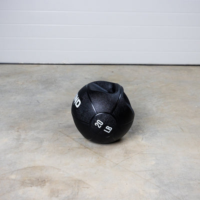 20 lb GRIND Dual-Grip Medicine Ball on floor.
