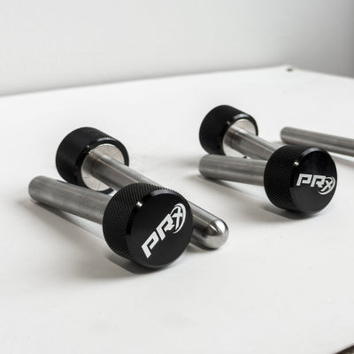 Pair of PRx Mag Pins on a white surface with a gray background