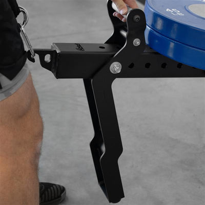 Black weight plate holder with blue weight plates on a gray floor.