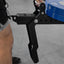 Black weight plate holder with blue weight plates on a gray floor.