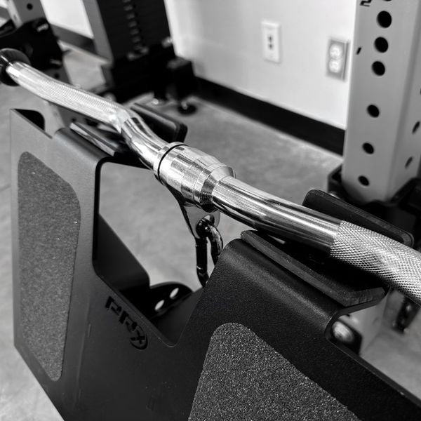 Close-up of a barbell with weight plates on a gym rack.