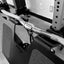 Close-up of a barbell with weight plates on a gym rack.