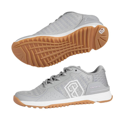Gray athletic shoe with brown sole on a light gray background