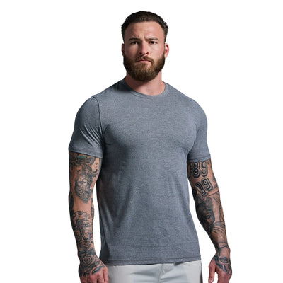 Man wearing a gray t-shirt against a plain background