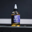 Bottle of Barbell Rescue multi-purpose lubricant oil on a metallic surface with a dark background