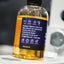 Bottle of liquid with a label on a blurred background