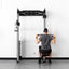 Person using a power rack in a home gym setting