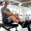 Man using a rowing machine in a gym setting