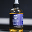 Bottle of Barbell Rescue multi-purpose lubricant oil on a dark background